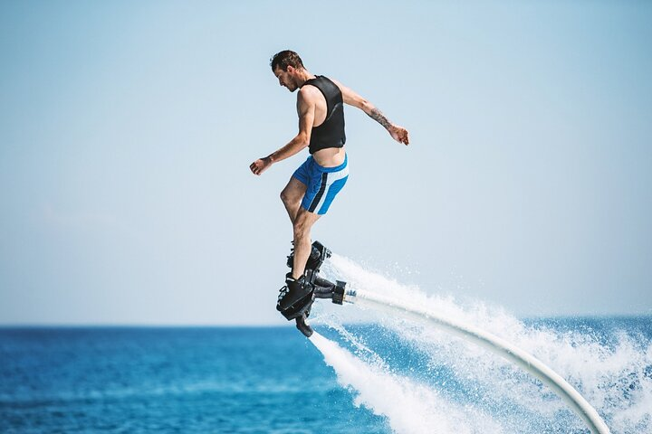 Soar above the azure waters of Dubai mastering the art of flyboarding—a unique mix of water sports excitement and aerial escapades perfect for adventurers seeking an unforgettable experience.